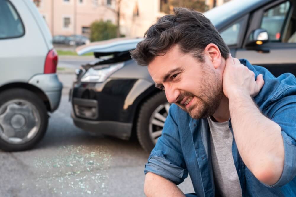 Man holding his neck in pain after a car accident